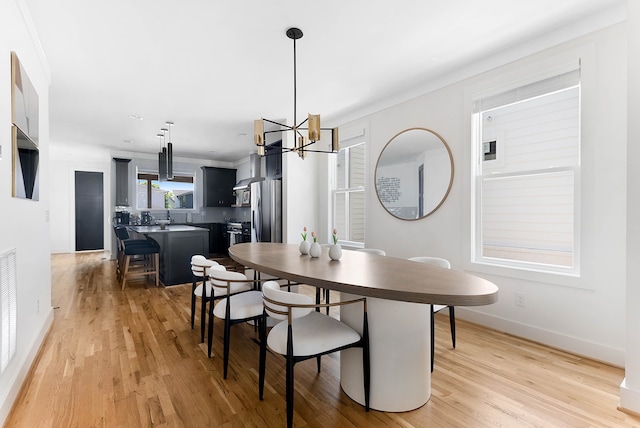 dining room featuring a notable chandelier and light hardwood / wood-style floors