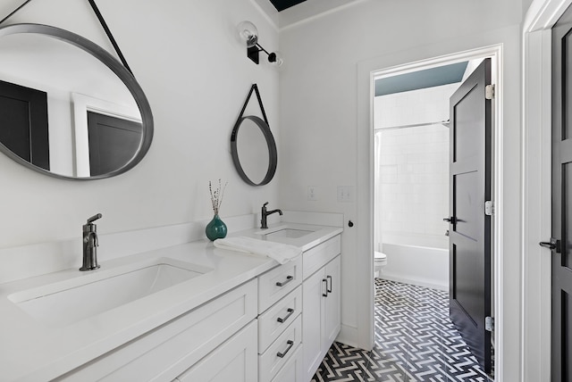 full bathroom with vanity, tiled shower / bath, and toilet