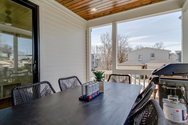 dining room with wooden ceiling and wood walls