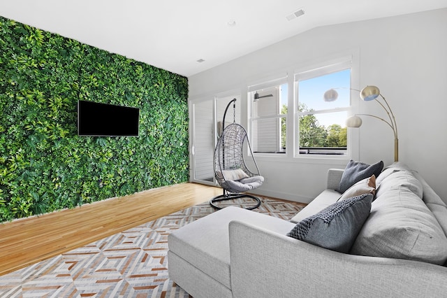 living room with light hardwood / wood-style floors and lofted ceiling