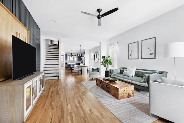 living room with ceiling fan and light wood-type flooring