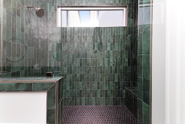 bathroom with a tile shower