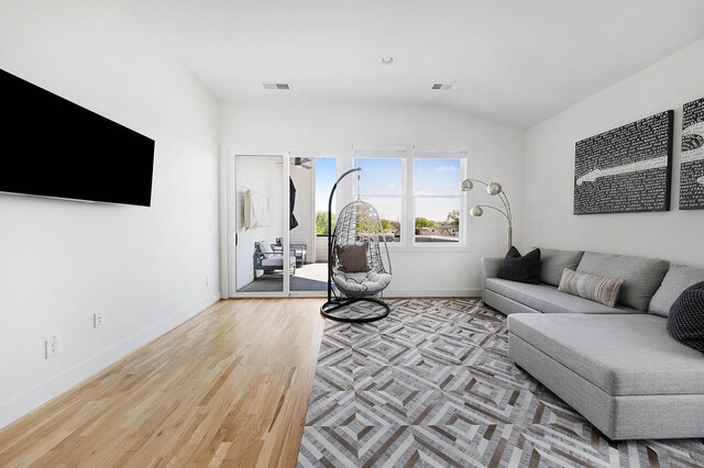 living room with lofted ceiling and light wood-type flooring