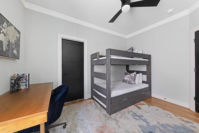 bedroom featuring ceiling fan, ornamental molding, and hardwood / wood-style flooring