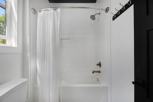 bathroom with toilet and shower / bathtub combination with curtain