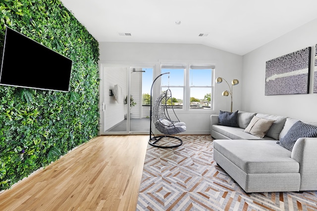 living room with lofted ceiling and light wood-type flooring