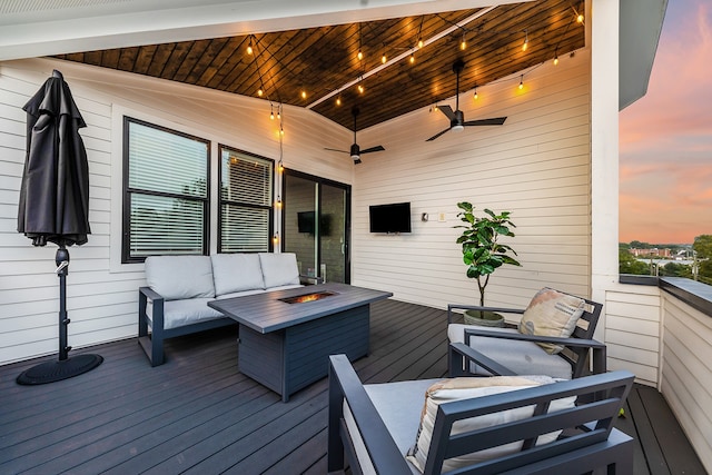 deck featuring an outdoor living space with a fire pit