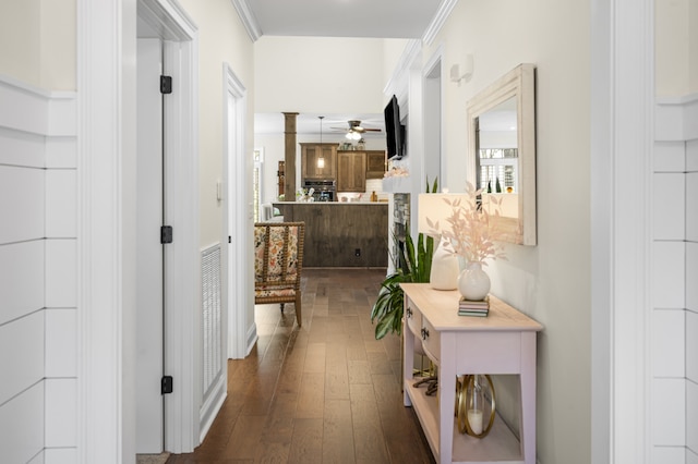 hallway with dark hardwood / wood-style flooring and crown molding