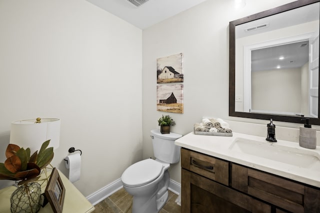 bathroom featuring tile patterned flooring, vanity, and toilet