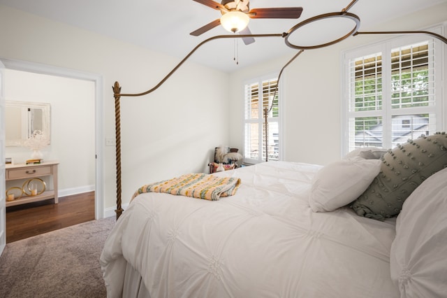 bedroom with dark hardwood / wood-style floors and ceiling fan