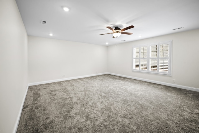 unfurnished room featuring ceiling fan and carpet