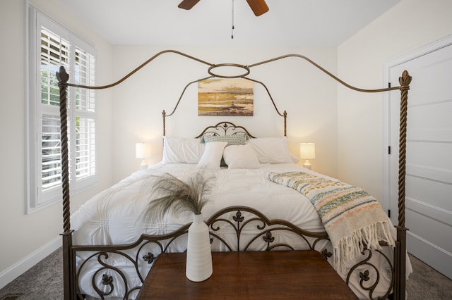 bedroom featuring ceiling fan and dark carpet