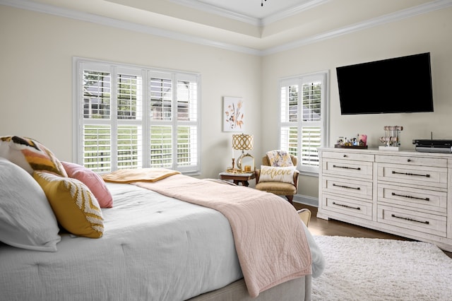 bedroom with dark hardwood / wood-style flooring, ornamental molding, and multiple windows