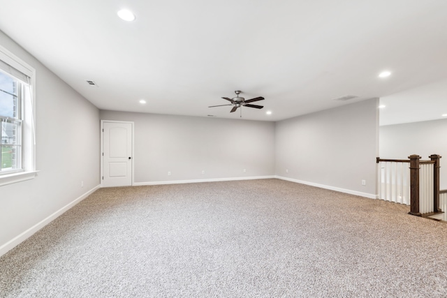 carpeted spare room with ceiling fan