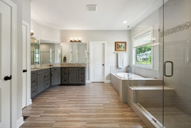 bathroom with plus walk in shower and vanity