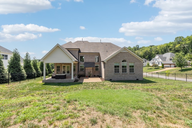 back of property featuring an outdoor living space, a patio, and a lawn