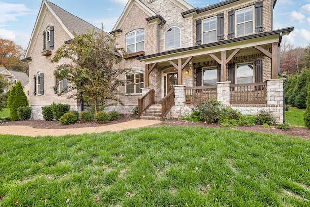 view of front of property with a front yard and a porch