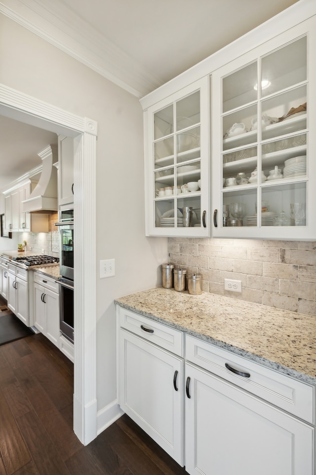 bar featuring white cabinets, custom exhaust hood, dark hardwood / wood-style flooring, and ornamental molding