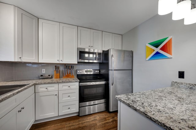 kitchen with dark hardwood / wood-style floors, white cabinetry, and stainless steel appliances