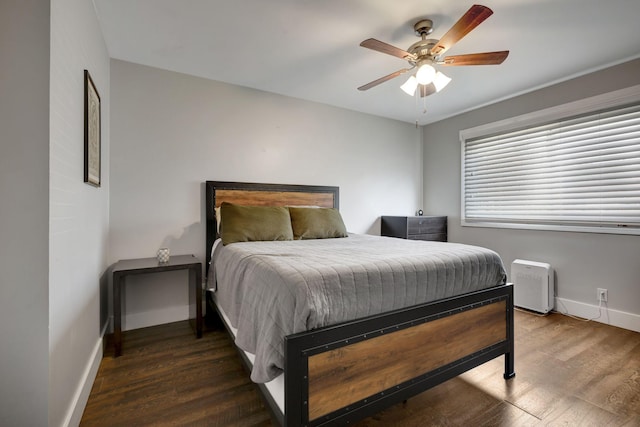 bedroom featuring dark hardwood / wood-style flooring and ceiling fan