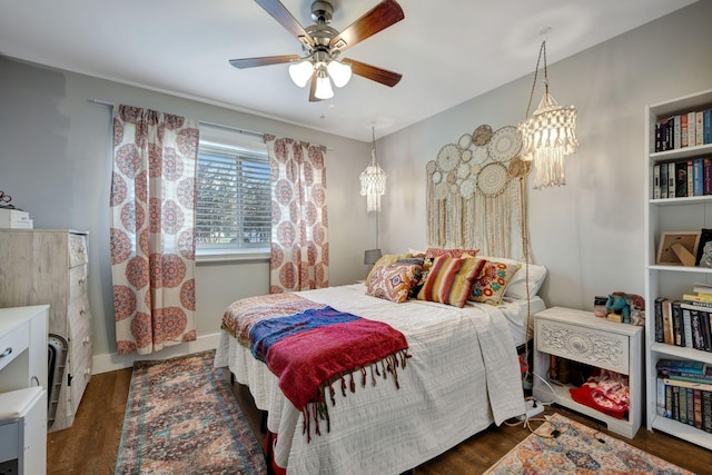 bedroom with ceiling fan and dark hardwood / wood-style floors