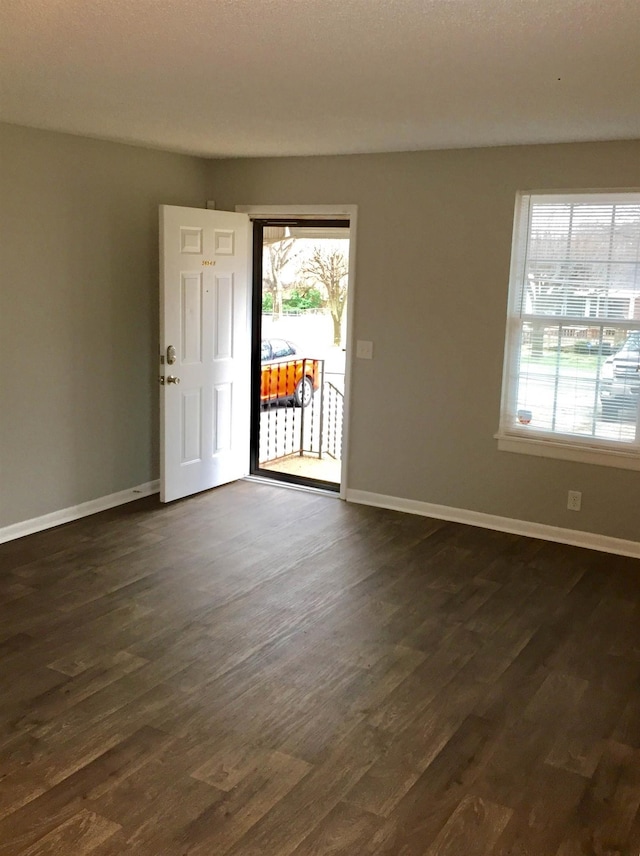 spare room featuring dark hardwood / wood-style floors