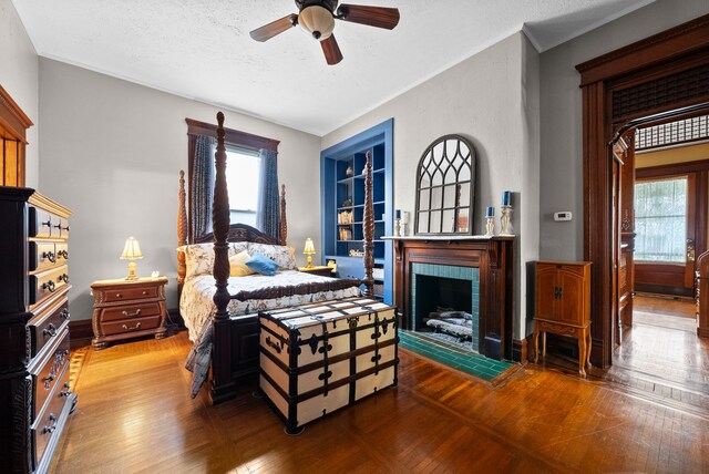 428 N Main St, Trenton, KY 42286 - bedroom with hardwood / wood-style flooring, ceiling fan, a fireplace, and a textured ceiling