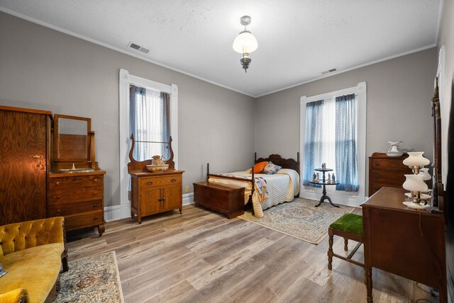 428 N Main St, Trenton, KY 42286 - bedroom with light hardwood / wood-style flooring, multiple windows, and ornamental molding