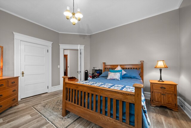 428 N Main St, Trenton, KY 42286 - bedroom featuring a notable chandelier, light hardwood / wood-style floors, and crown molding