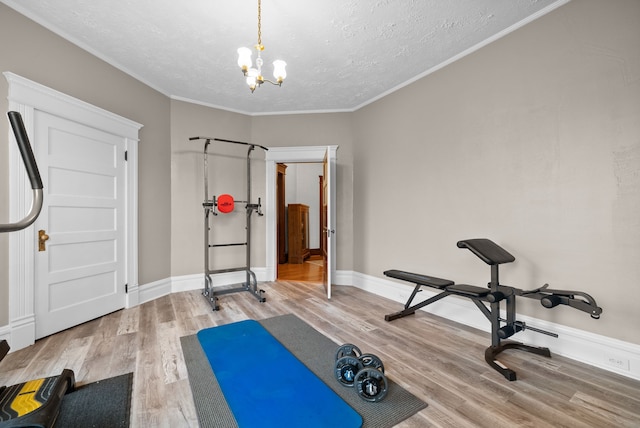 428 N Main St, Trenton, KY 42286 - workout room featuring a textured ceiling, ornamental molding, a notable chandelier, and hardwood / wood-style flooring