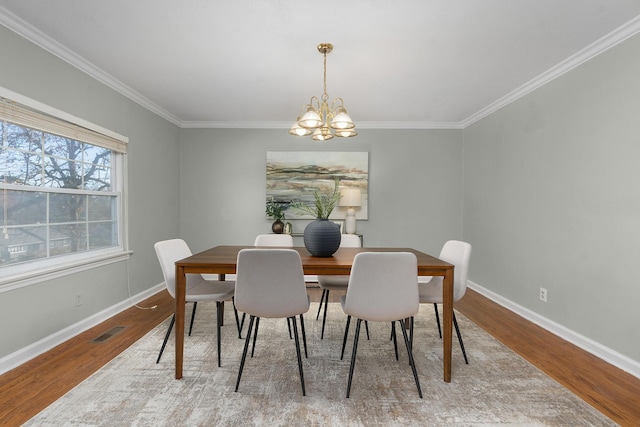 1206 Peter Pan Rd, Lookout Mountain, GA 30750 - dining area featuring wood finished floors, crown molding, a chandelier, and baseboards