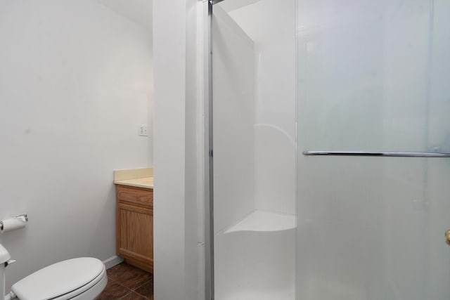 1206 Peter Pan Rd, Lookout Mountain, GA 30750 - bathroom featuring a stall shower, vanity, toilet, baseboards, and tile patterned floors