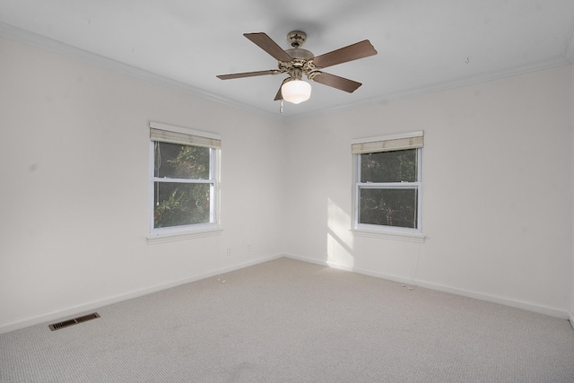 unfurnished room with ceiling fan, carpet, and ornamental molding