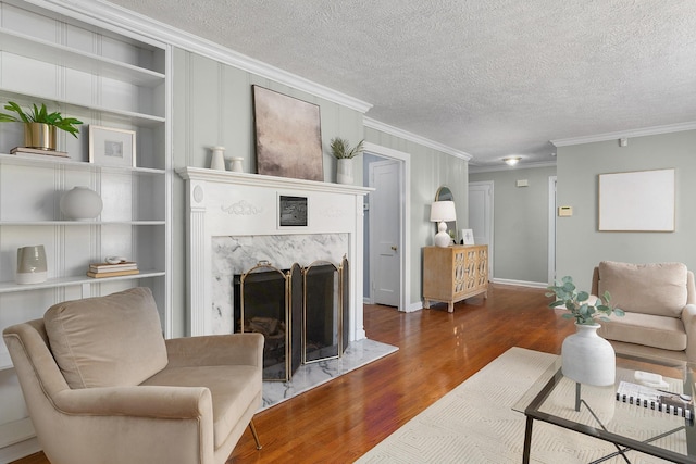 1206 Peter Pan Rd, Lookout Mountain, GA 30750 - living area featuring ornamental molding, wood finished floors, a high end fireplace, a textured ceiling, and built in shelves