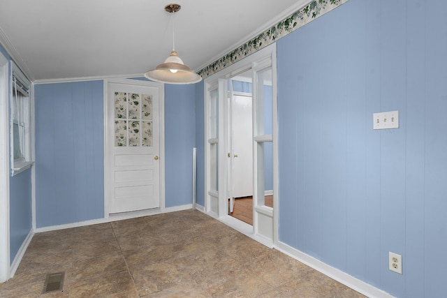 spare room with wood walls and crown molding