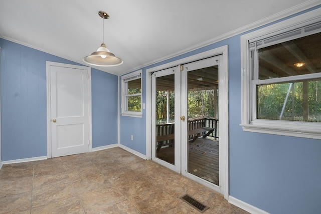 empty room with a wealth of natural light, crown molding, and vaulted ceiling