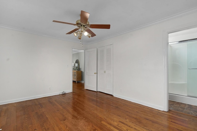 1206 Peter Pan Rd, Lookout Mountain, GA 30750 - unfurnished bedroom featuring crown molding, baseboards, wood finished floors, a ceiling fan, and multiple closets
