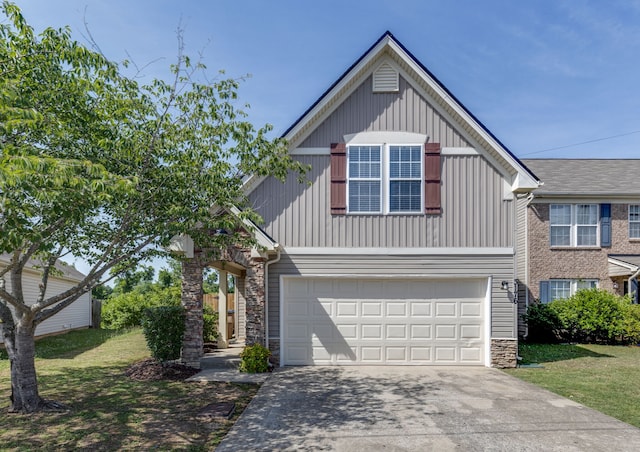 view of front of home with a front yard and a garage