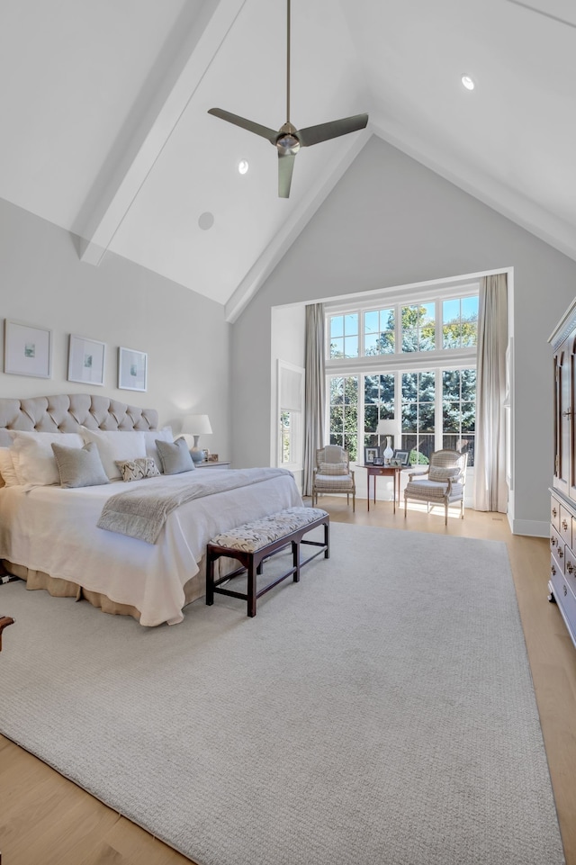 bedroom with ceiling fan, high vaulted ceiling, and light hardwood / wood-style flooring