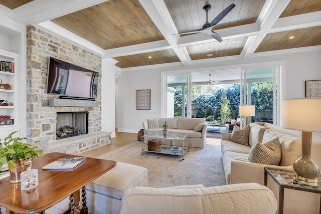 living room featuring coffered ceiling, light hardwood / wood-style flooring, built in shelves, a fireplace, and beam ceiling