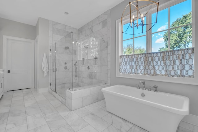 bathroom with independent shower and bath and an inviting chandelier