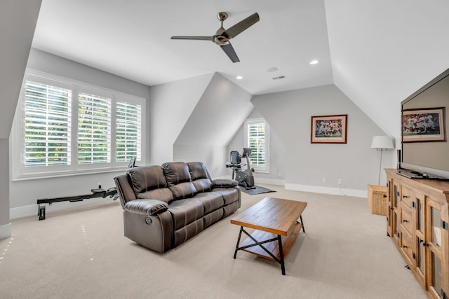 carpeted living room with lofted ceiling, ceiling fan, and a healthy amount of sunlight