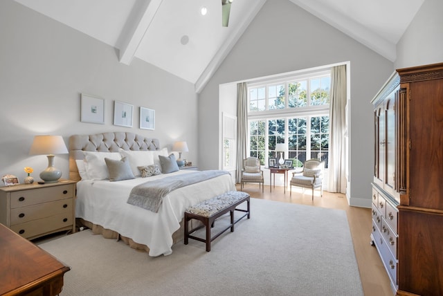 bedroom featuring beamed ceiling, light wood-type flooring, and high vaulted ceiling