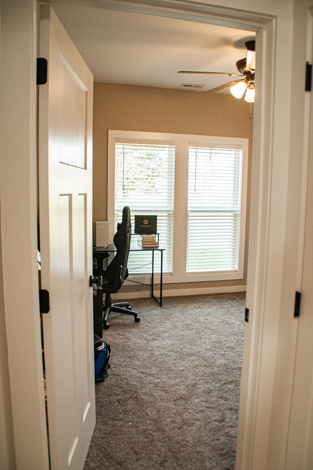 carpeted office featuring ceiling fan