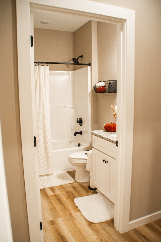 full bathroom with toilet, vanity, shower / bath combo, and hardwood / wood-style flooring