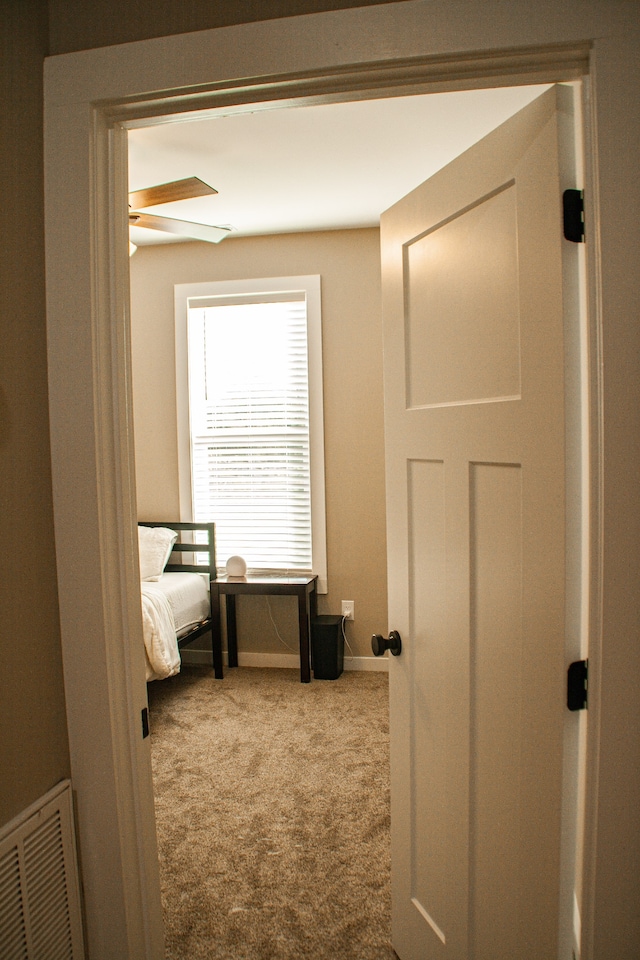 carpeted bedroom featuring ceiling fan