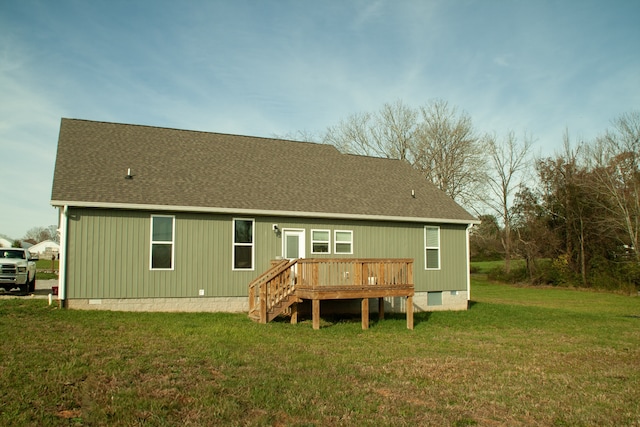 rear view of property featuring a deck and a yard