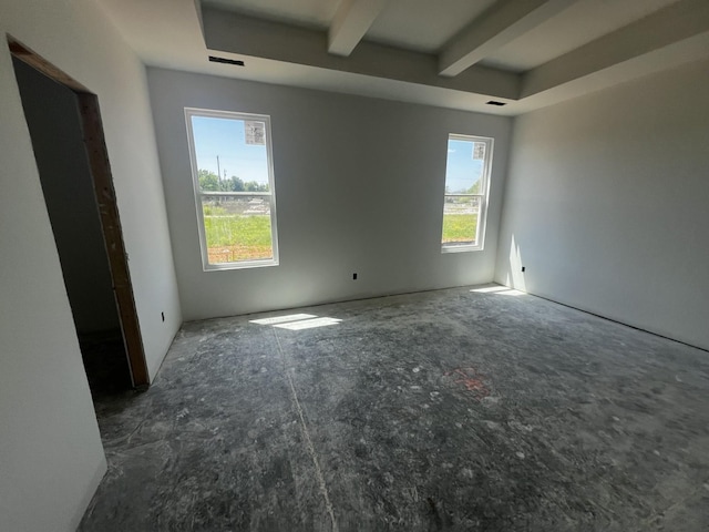 empty room featuring beam ceiling