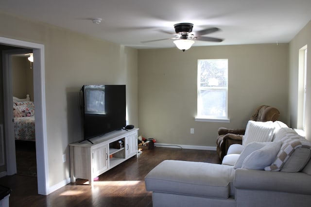 living room with ceiling fan and dark hardwood / wood-style flooring