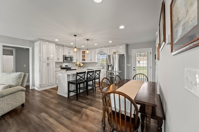 dining area with dark hardwood / wood-style flooring and sink